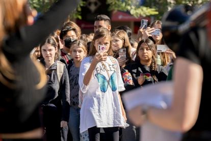 Young students film during a protest at a school in Santa Ana, California, November 2022.