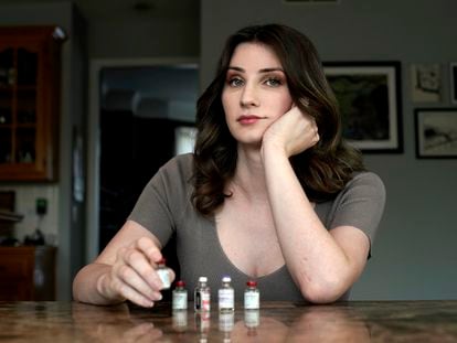 Transgender woman Stacy Cay displays some of the hormone therapy drugs she has stockpiled in fear of losing her supply, Thursday, April 20, 2023, at her home in Overland Park, Kan.
