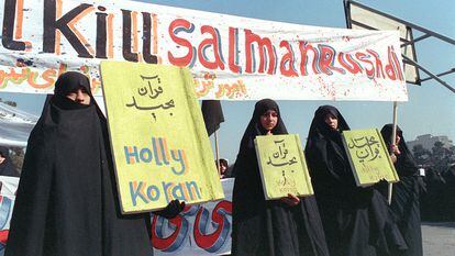 In this file photo taken on February 17, 1989, Iranian women are seen holding banners which read "Holly Koran" and "Kill Salman Rushdie" during a demonstration against British writer Salman Rushdie in Tehran.