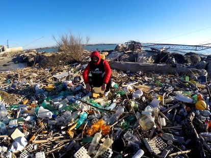 A volunteer of the Plastic Free association, cleans up the "Plastic Beach" of the Volturno, so called for the enormous amount of accumulated waste brought by the flood of the Volturno river.