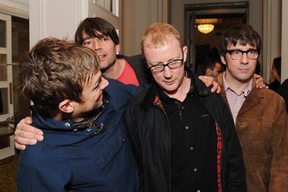 Damon Albarn hugs Dave Rowntree (behind them, Alex James and Graham Coxon) at the Q magazine awards in London in 2012