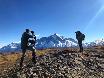 Documentary filmmaker, René Araneda, with binoculars, and cameraman, Benjamin Goertzen, in Torres del Paine.