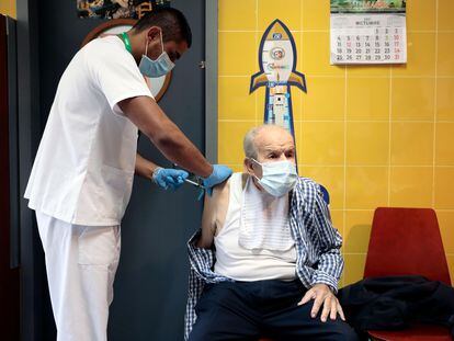 A man in Valencia attends a healthcare center to get his Covid-19 booster shot and flu vaccine.