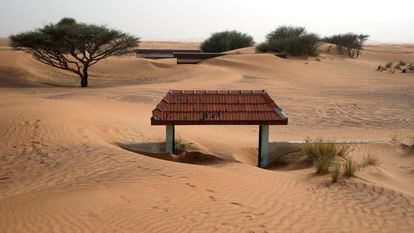 A house's entrance gate is buried under the sand at the Bedouin village of al-Ghuraifabout 100 km, 62 miles, southeast of Sharjah, United Arab Emirates, Sunday, July 9, 2023.