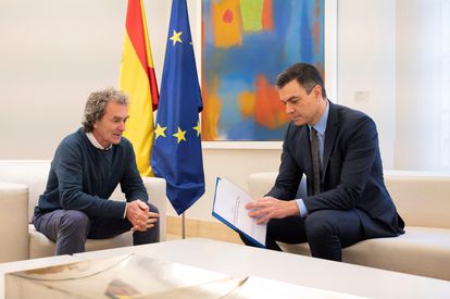 Health official Fernando Simón (l) hands PM Pedro Sánchez the report with recommendations on the transition strategy.