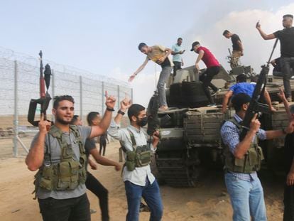 A group of Palestinians ride a military vehicle through the streets of Gaza on Saturday.