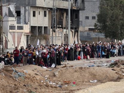 Dozens of Palestinians wait on Wednesday before leaving northern Gaza through a humanitarian corridor.