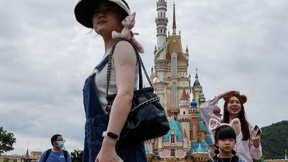 Visitors stands in front of the Castle of Magical Dreams at Hong Kong Disneyland, China October 13, 2023.