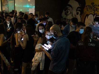 A security guard checks ‘Covid passports’ outside Apolo nightclub in Barcelona.