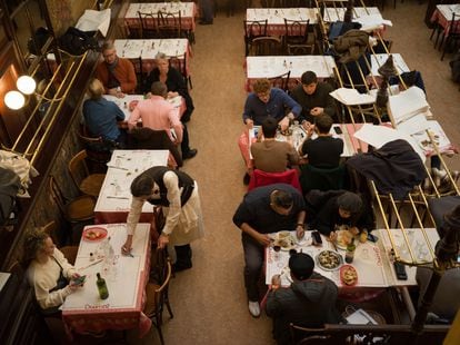The dining room packed with people during the food service at the Bouillon Chartier, in Paris 


