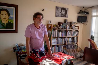 Pastor Alape shows his collection of Deportivo Independiente Medellín jerseys.