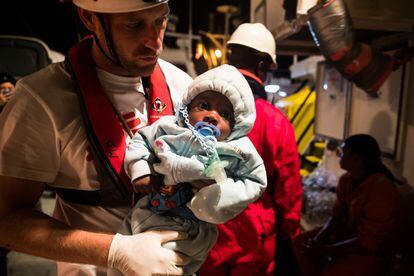 The head doctor on the ship, David, holds a rescued baby, on June 8.