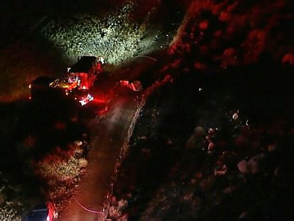This aerial image taken from video provided by ABC7 Los Angeles shows the scene of a firefighting helicopter crash, with emergency vehicles at the base of a mountain and the area blocked off with police tape, in Cabazon, Calif., Sunday, Aug. 6, 2023.