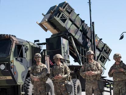 Army soldiers stand next to a Patriot surface-to-air missile battery during the NATO multinational ground based air defense units exercise in Lithuania, in July 2017.