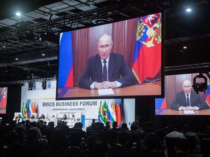President of Russia Vladimir Putin appears on a monitor as he delivers a recorded speech off location during the 15th BRICS Summit in Johannesburg, South Africa, on August 22, 2023.