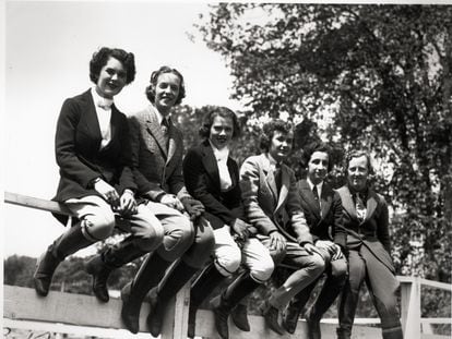 Smith College students sit on a fence, in Northampton, Massachusetts.