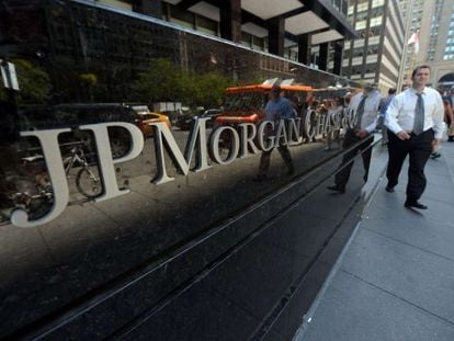 This file photo taken on August 14, 2013 shows people walking by JP Morgan Chase &amp; Company headquarters in New York. 