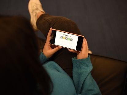 A user plays the English version of Wordle on his cell phone.