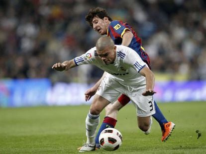 Real Madrid&#039;s Pepe tries to protect the ball under challenge from Barcelona&#039;s Leo Messi during an April, 2011 cl&aacute;sico.