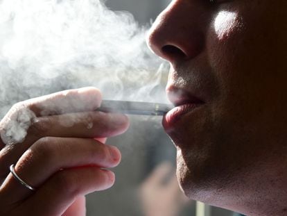 An illustration shows a man exhaling smoke from an electronic cigarette in Washington, DC.