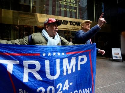 A supporter of former president Donald Trump, and a man impersonating the former president stand outside of Trump Tower on March 31, 2023, in New York.