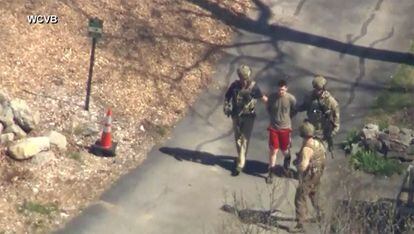 This image made from video provided by WCVB-TV, shows Jack Teixeira being taken into custody by armed tactical agents on April 13, 2023, in Dighton, Massachusetts.