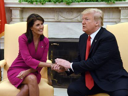 In this file photo taken on October 09, 2018, US President Donald Trump shakes hands with Nikki Haley, the United States Ambassador to the United Nations, in the Oval Office of the White House.