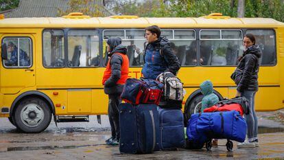 Civilians evacuated from the Russian-controlled city of Kherson wait to board a bus heading to Crimea, in the town of Oleshky, Kherson region, Russian-controlled Ukraine October 23, 2022.
