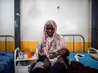 A mother holds her son in her arms at Trócaire Hospital, which treats infant malnutrition, in Dolow, Somalia.