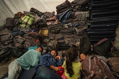 A family of Venezuelan migrants rests inside the parish.
