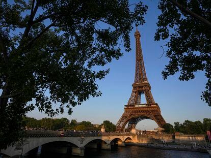 People walk on the Iena bridge leading to the Eiffel Tower in Paris, Thursday, June 1, 2023. The first Olympic Games since the ebb of the COVID-19 pandemic open in a year in France’s capital.