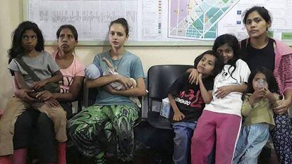 Patricia Aguilar, third from left, holding her baby after being rescued.