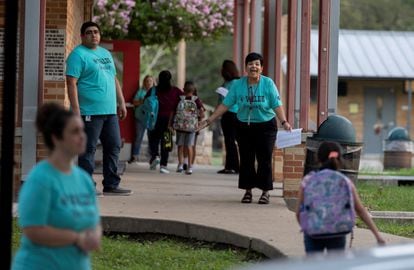 A girl runs to greet her teacher on the first day of classes at Uvalde Elementary.