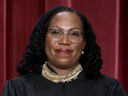 Associate Justice Ketanji Brown Jackson stands as she and members of the Supreme Court pose for a new group portrait following her addition, at the Supreme Court building in Washington, Oct. 7, 2022.
