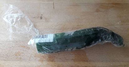 A cucumber wrapped in plastic.