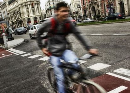 A cyclist rides the bike path on Alcalá street.