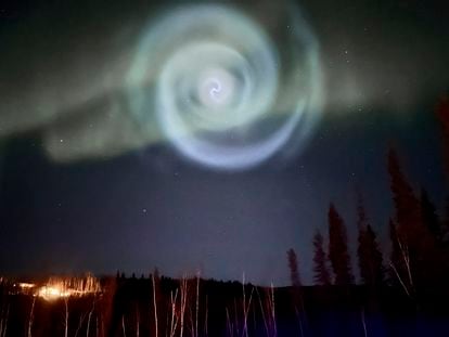 A light baby blue spiral resembling a galaxy appears amid the aurora for a few minutes in the Alaska skies near Fairbanks