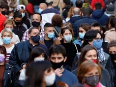 Pedestrians wearing face masks in a shopping strip of Barcelona, in April.