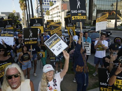 Actor and SAG-AFTRA negotiator Frances Fisher, middle, raises her sign on a picket line outside Netflix studios on Tuesday, Sep. 26, 2023, in Los Angeles.