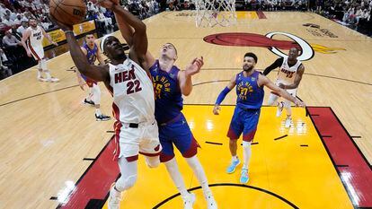 Jimmy Butler (Miami Heat) goes to the basket against Nikola Jokic (Denver Nuggets) on Wednesday in Miami, in Game 3 of the NBA Finals.