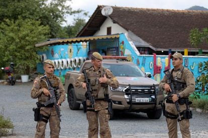 Security forces stand guard outside the private preschool where an attacker killed four children with a bladed weapon, in Blumenau, Santa Catarina State, in southern Brazil, on April 5, 2023.