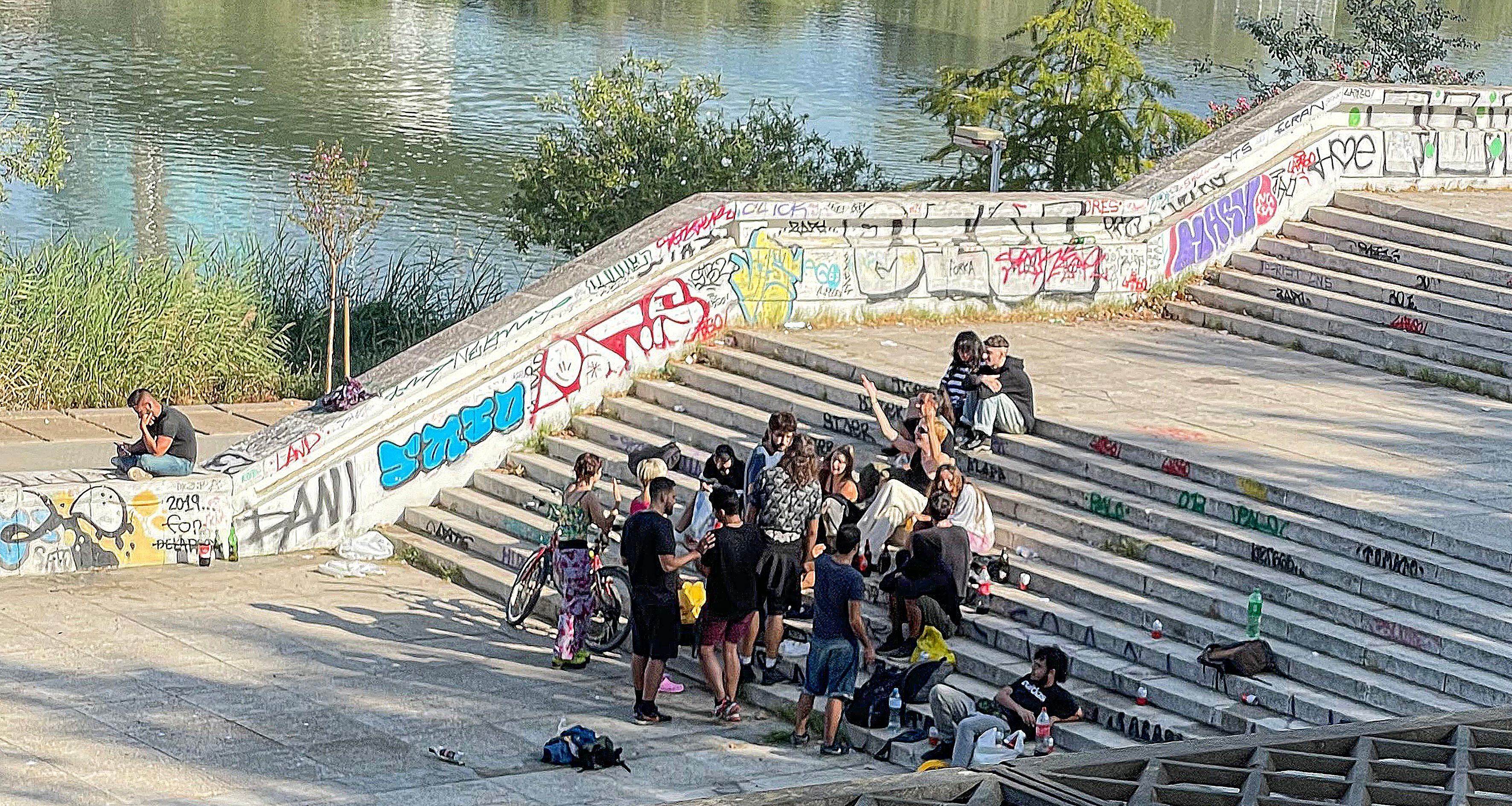 An outdoor drinking party by the Guadalquivir river.
