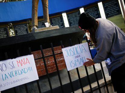 A journalist places a banner during a protest demanding justice after the murder of photojournalist Ismael Villagomez Tapia of the local newspaper El Heraldo de Juarez