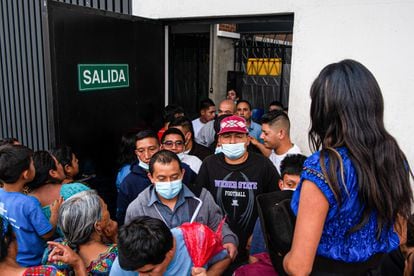 Deported Guatemalans exit the airport arrival area.