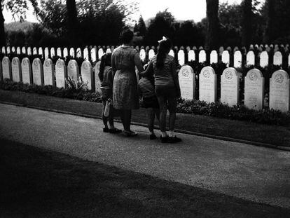 Pictured are the girls and women who are the subjects of the majority of images in the Randstad 1969 exhibition. They observe tombstones in a cemetery, at some point in the 1960s,