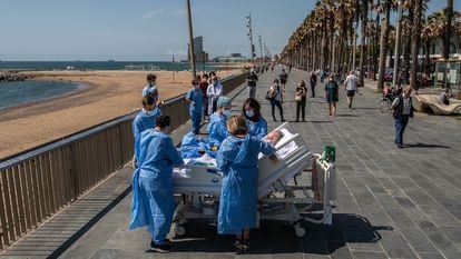 Staff at the Mar de Barcelona hospital take a Covid-19 patient to the seaside as part of a program to humanize intensive care treatment.