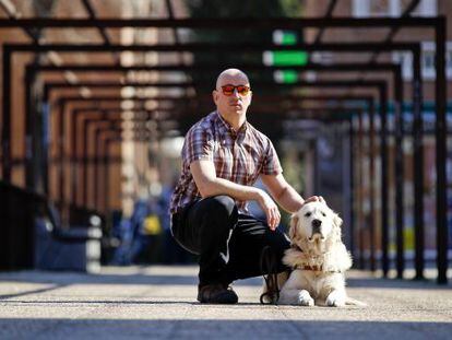 Raúl Fernández with his guide dog, close to his home in Madrid.
