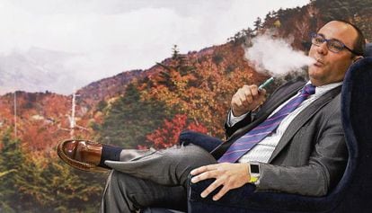 Manuel Muñoz, head of the Spanish National Electronic Cigarette Association, enjoys a vape.