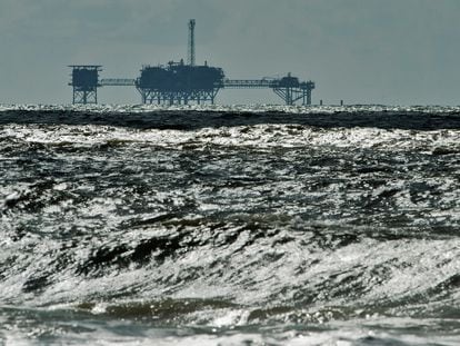 An oil and gas drilling platform stands offshore in Alabama, October 5, 2013.