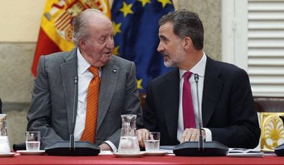 Spain's emeritus king Juan Carlos I with his son, King Felipe VI, in a file photo from 2019.